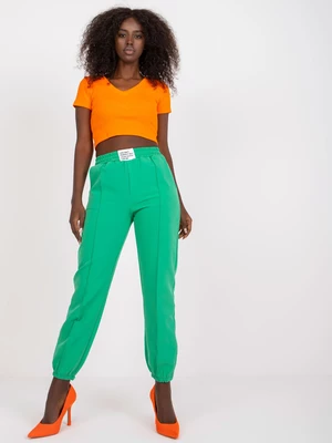 Dark green women's trousers made of fabric with wrinkled