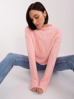 Light pink cable knit sweater with a round neckline