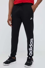 Bavlněné tepláky adidas černá barva, s potiskem