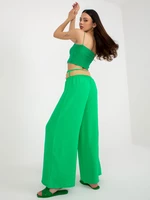 Green wide trousers made of fabric with a belt
