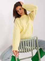 Light yellow sweater with cables and cuffs