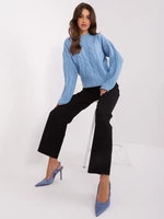 Light blue women's sweater with cables