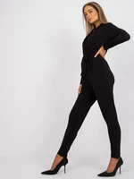 Black monochrome jumpsuit with Serafini belt