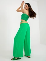 Green wide trousers made of fabric with a belt