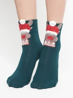 Socks with reindeer application in a green Christmas hat