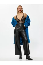 Koton Wide-leg pants with a leather look and mini pockets.