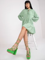 Light green dress in boho style with frills