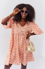 Loose dress with puffed sleeves in light orange